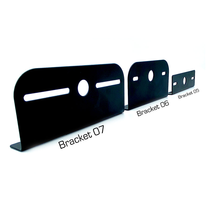 Mounting Bracket For Directional Lights (L-Shape), featuring black metal design with circular and mounting holes, suitable for various trailer models.