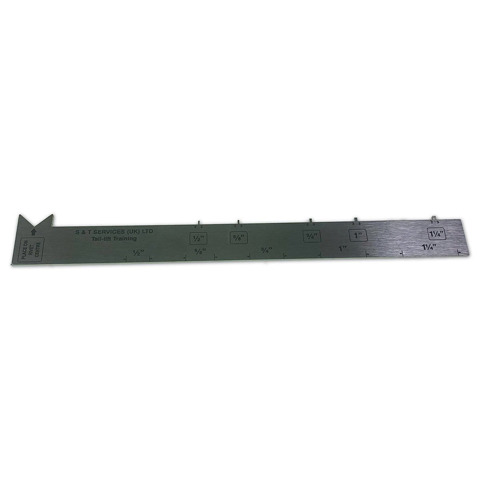 Chain Measuring Gauge, a long metal tool with holes and marked numbers, used for precise chain measurements in commercial trailer maintenance.